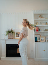 A lady wears a pair of white pants